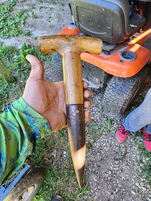 Wood handle metal like cover towards the bottom like spike found in a shed in a house we just bought.