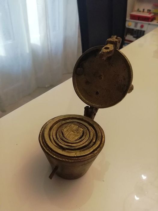 Discovered small brass cups that nest inside each other and lock shut. Any guesses on what they are?