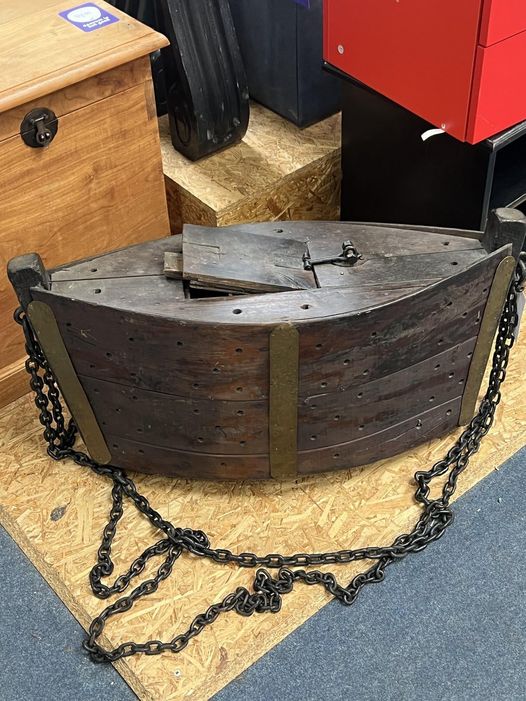 Located at a thrift store, this piece is made of hardwood, has a sturdy iron chain link, brass plates, and is hollow on the inside.